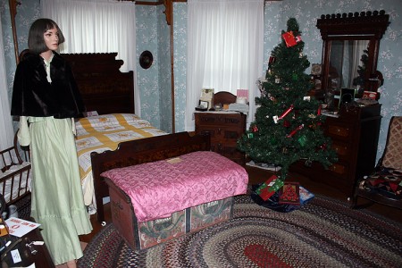 A bedroom in the Grinnell Historical Museum, decked out for the holidays. After purchasing the house, the City of Grinnell put out a call to collect items of historic value to create the museum, such as medicine bottles, bedframes, pictures and paintings of local residents from the past 150 years - Aaron Barker