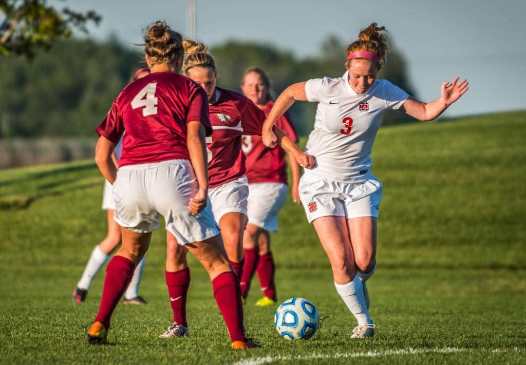 Lauren+Hurley+%E2%80%9918+dribbles+past+Coe+College+defenders+on+Tuesday%2C+Sept.+16.+Photo+by+Chris+Lee.+