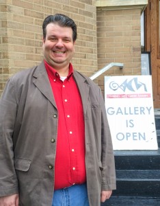 Christian Lutz smiles outside the Grinnell Arts Center Gallery. Photo contributed.