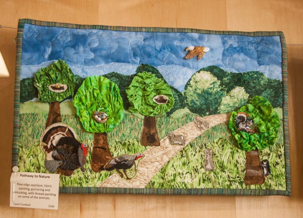 One+of+the+quilts+on+display%2C+%E2%80%9CPathway+to+Nature%2C%E2%80%9D+featuring+turkeys%2C+squirrels+and+trees.+Photo+by+Sydney+Steinle.+