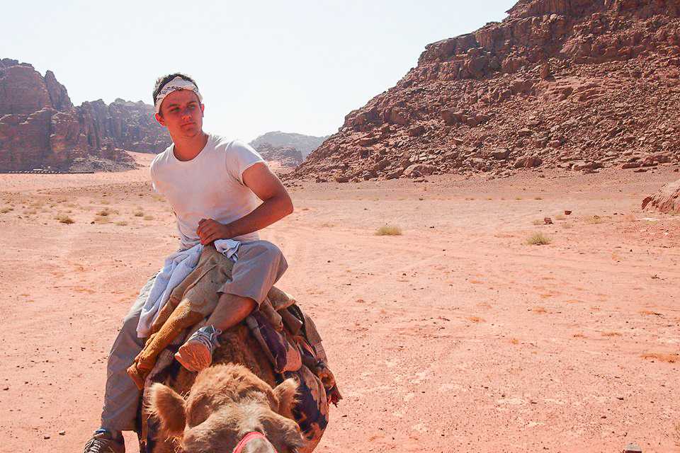 Sam+Curry+%E2%80%9916+sits+atop+a+camel+in+Amman%2C+Jordan+during+his+study+abroad+program+last+fall.+Photo+contributed