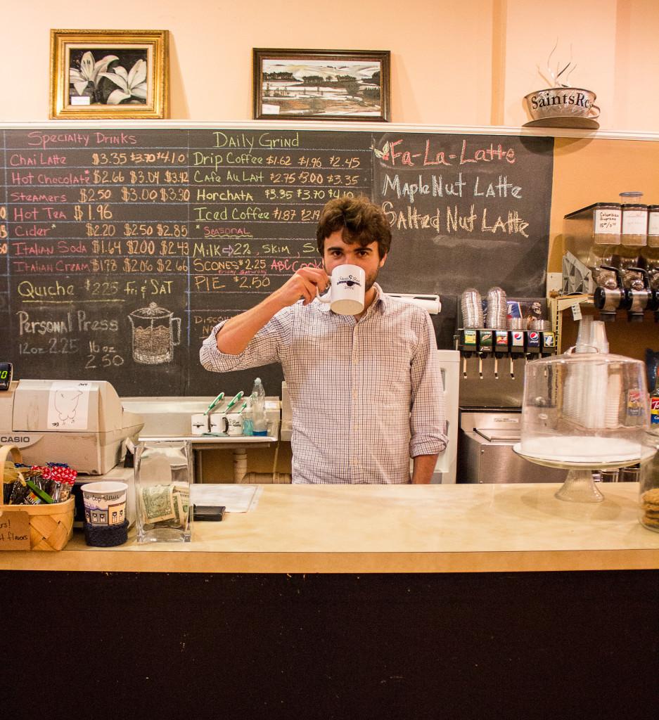 The S&B coffee expert and barista Sam Catanzaro ’16 takes a sip of a cup of Joe behind their counter. (Photo by Sarah Ruiz.)
