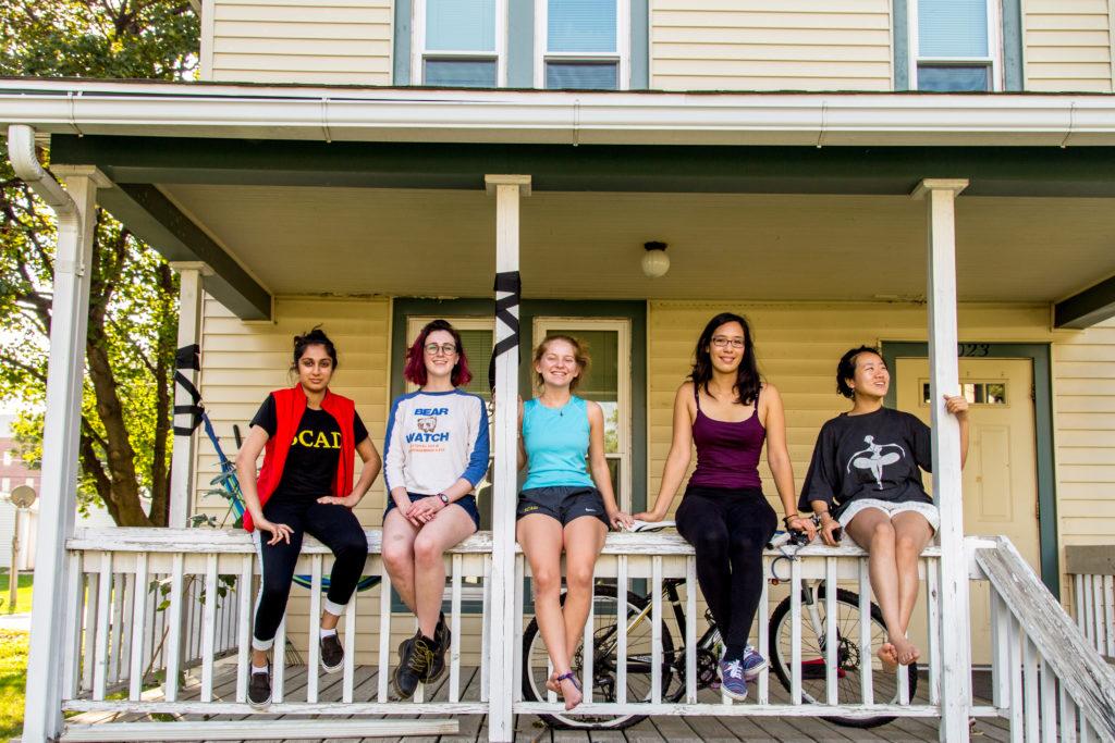Radhika Malaviya ’18, Anna Warm 19, Vivian Cheslack 19, Leina’ala Voss ’18 and Jinlin He 18 sit on the porch of Art House, a new project house. Photo by Garrett Wang. 