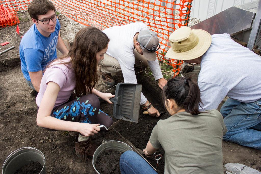 Students excavate the Peace Rock, which had not seen the light of day in over 100 years. Photo by Sarah Ruiz.