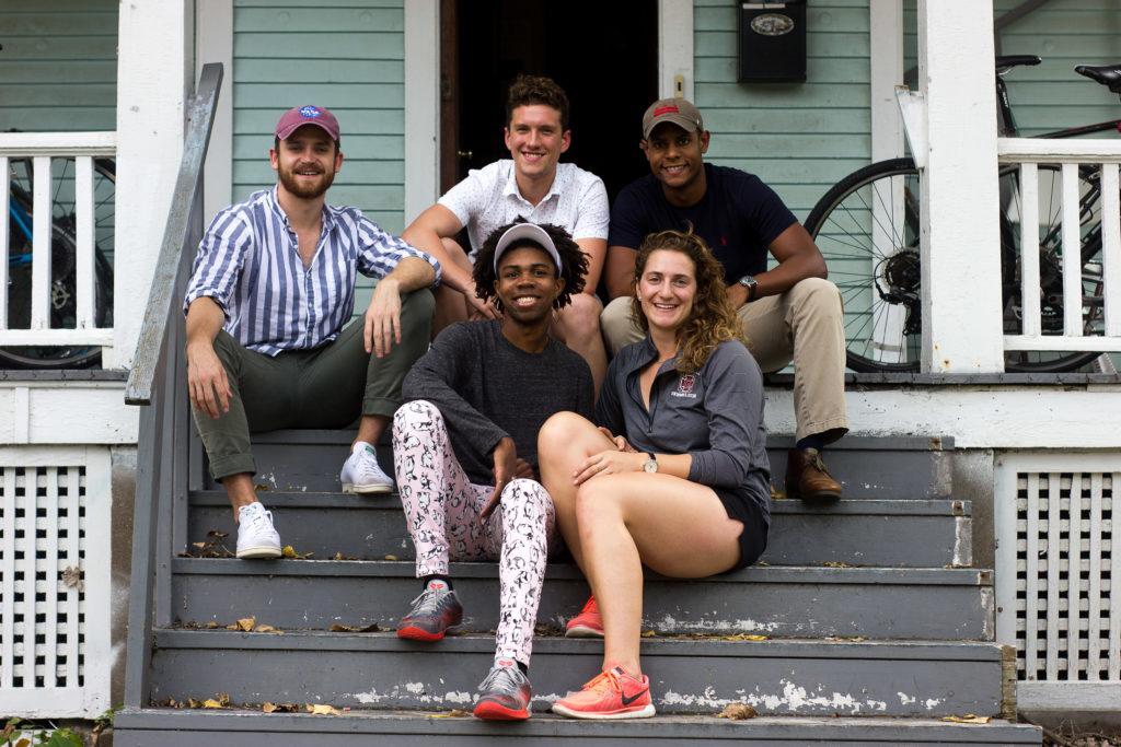 Nick Roberson, Josh Cottle, Michael Lee, Kahlil Epps and Maria Venneri, all 18, and all members of the swim team pose on the porch of their home, the infamous Fairgrounds. PHOTO BY GOVIND BRAHMANYAPURA
