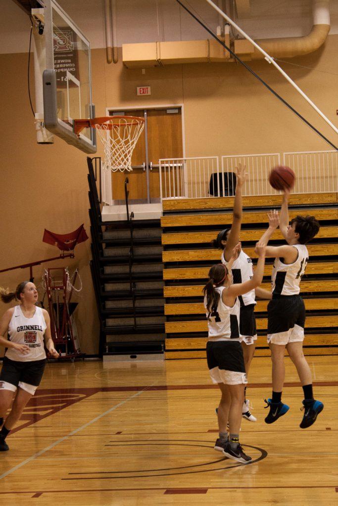 Hanna Kessel ’19 attempts a floater over teammates in practice. Photo by Reina Shahi.