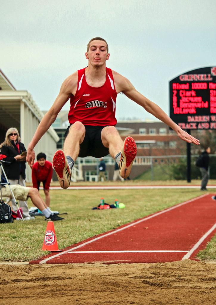 Brad Geiman ’21 jumps feet first into the long jump pit on Saturday. Contributed photo.