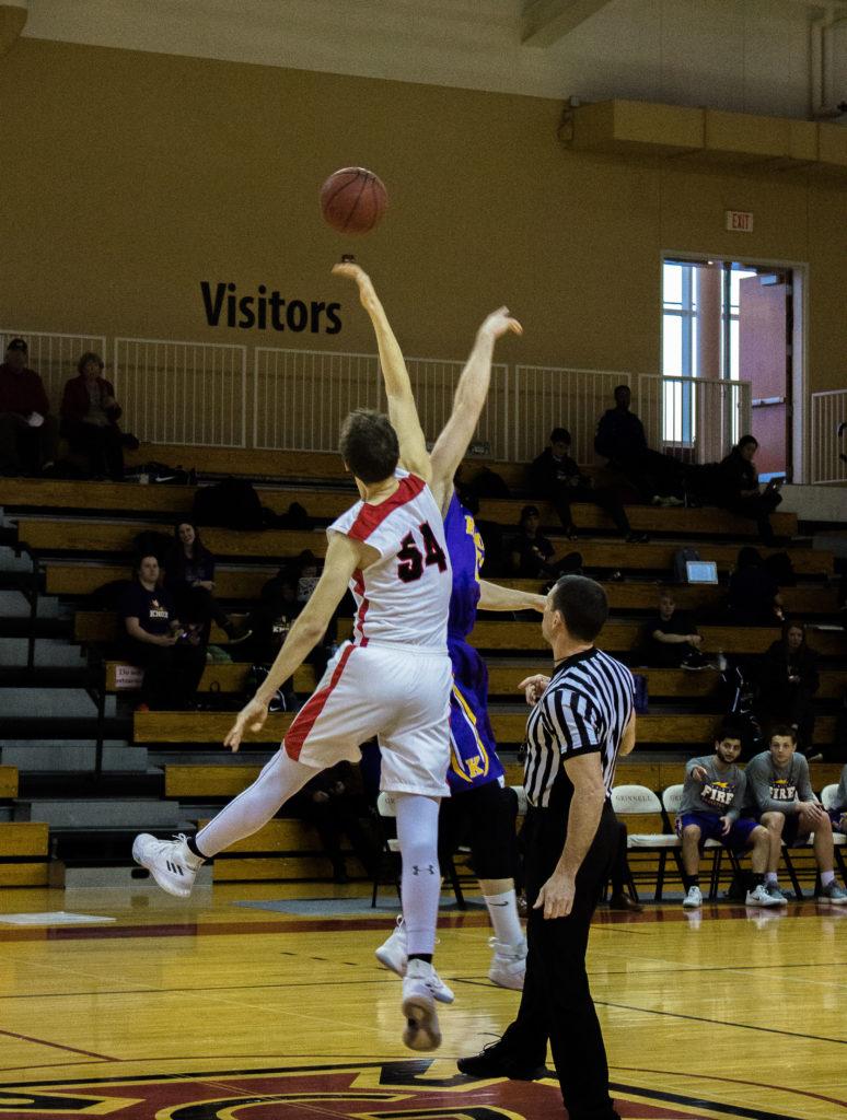 Tommy Smith 21 blocks a shot against an opponent. Photo by Reina Shahi.