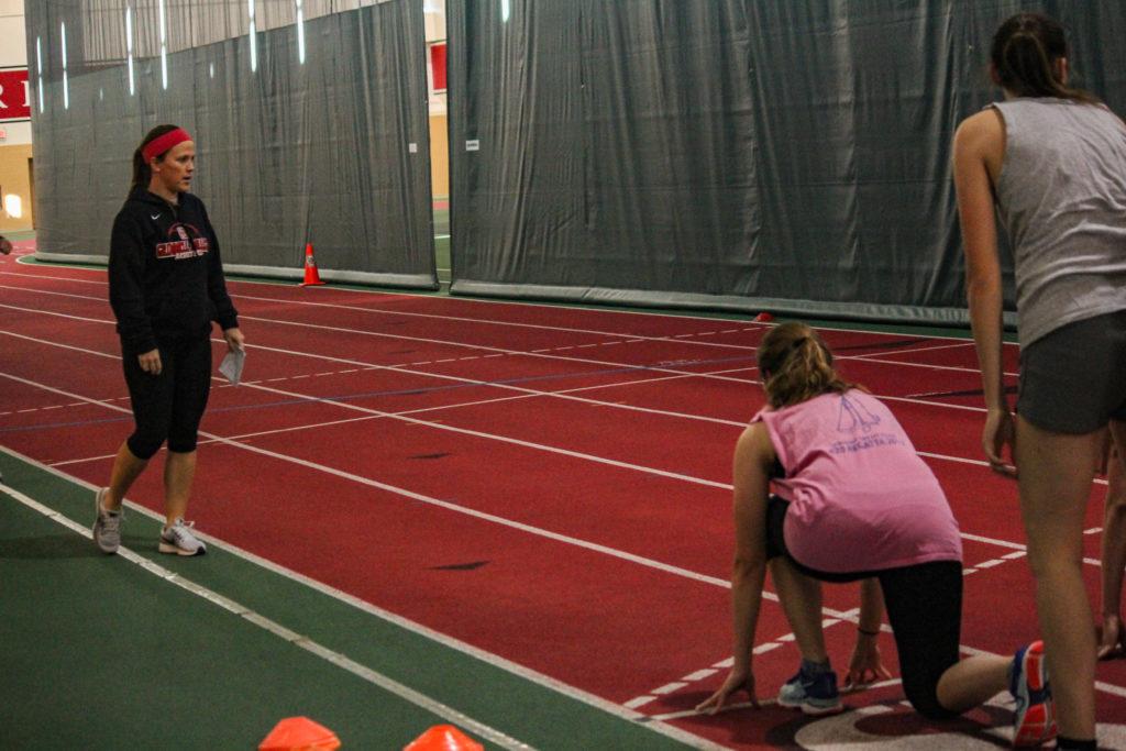 Coach+Harrold+advises+student-athletes+during+a+speed+and+agility+session.