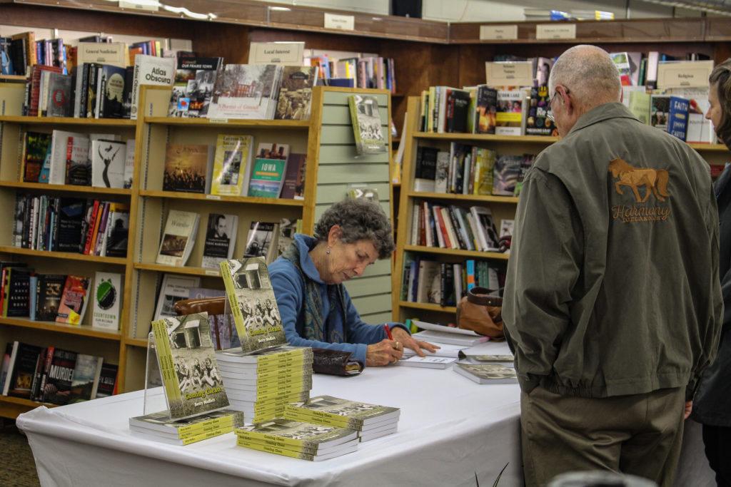 Betty Moffett signs copies of her new book, “Coming Clean,” after a reading hosted by Pioneer Bookstore on Wednesday, Oct. 10. Copies of the book will continue to be sold at Pioneer Bookstore. Photo by Liz Paik.