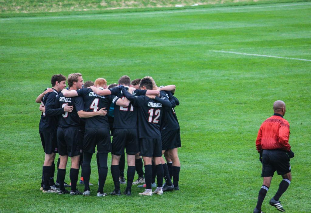 The mens soccer team in a huddle during Family Weekend. Contributed.