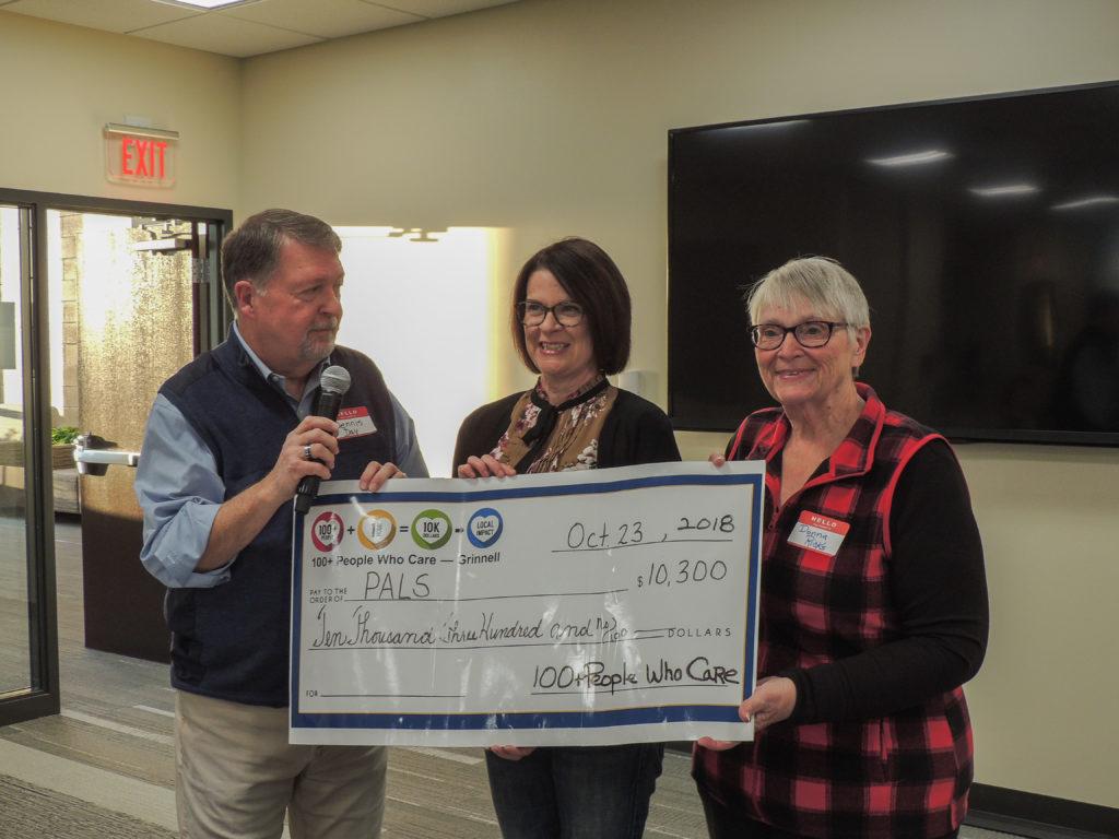100+ People Who Care - Grinnell present the $11,100 check to Sandi Cox, a representative from the Grinnell Community Daycare and Preschool. Contributed Photo.