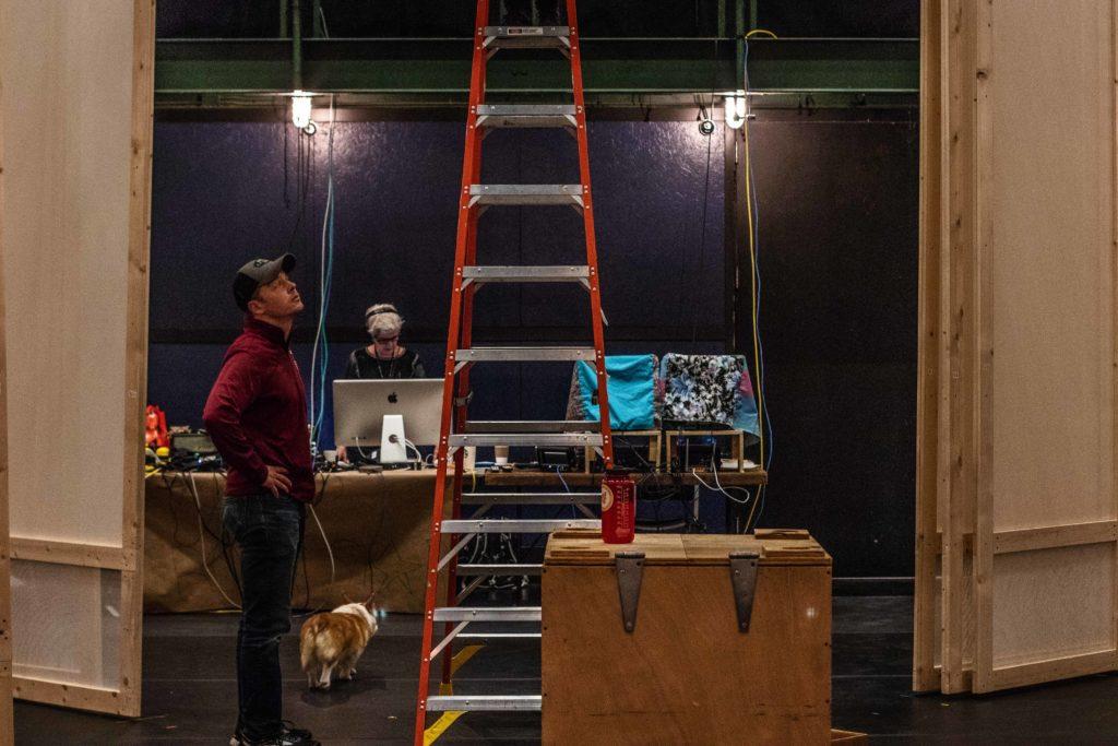 Justin Thomas, associate professor of scenic and lighting design, examines the set for Dance Ensemble’s “Salt Marsh Suite” set. Photo by Sarina Lincoln.