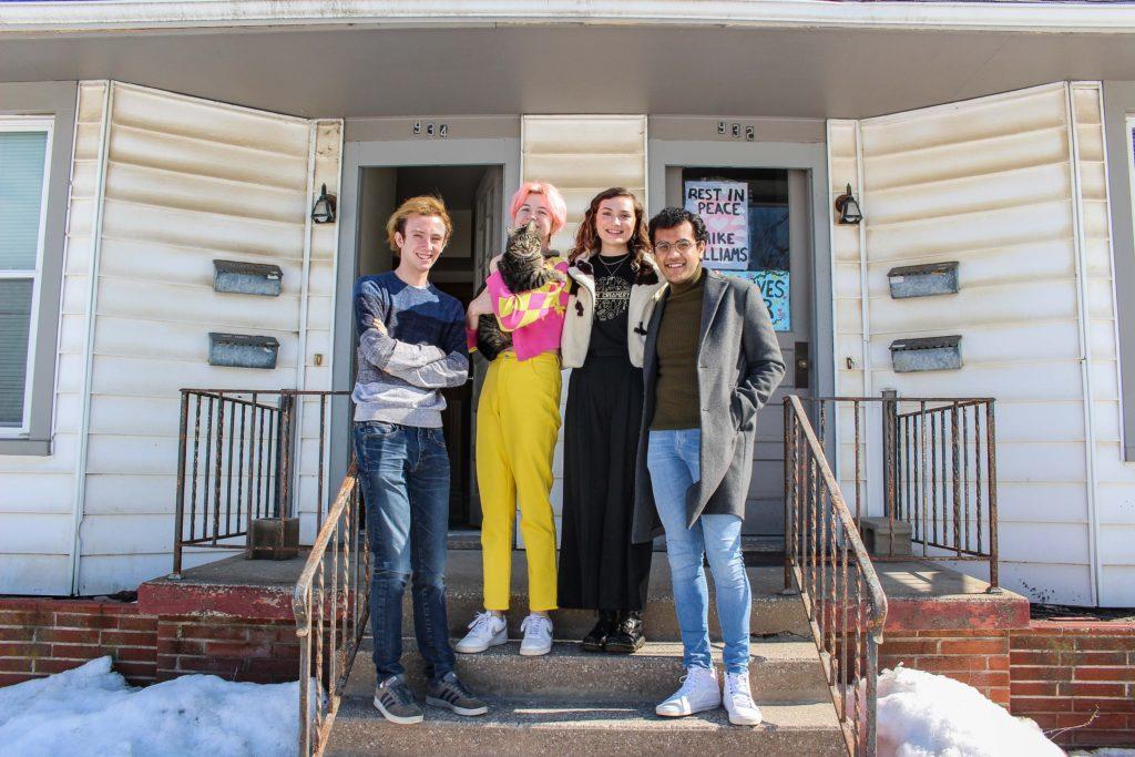 Despite the circumstances, the residents of 934 High Street are able to make their senior year memorable. From left to right are Conner Stanfield, Audrey Boyle (holding Henrik the cat), Sophia Schott and Ahon Gooptu, all `21. Photo by Kaya Matsuura.