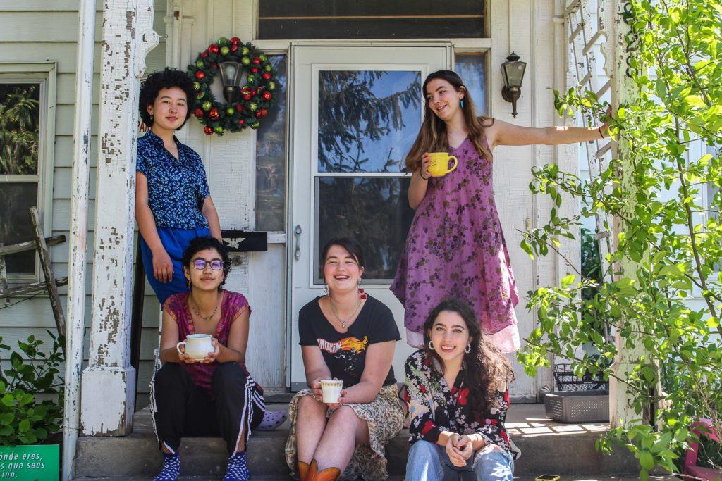 Sarina Lincoln, Chloe Wray, Elena Copell, Maya Kusunoki-Martin and Zoe Fruchter, all `21 pose on the front porch of their house on Park Street. 