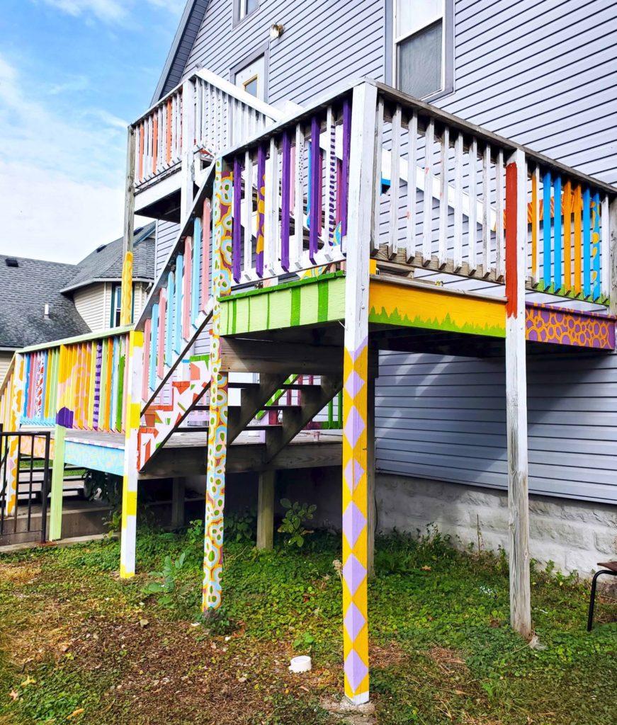 When deciding on a project everyone could be involved in, Art House residents set their sights on the unpainted two-story back porch.  Photo by Shabana Gupta. 