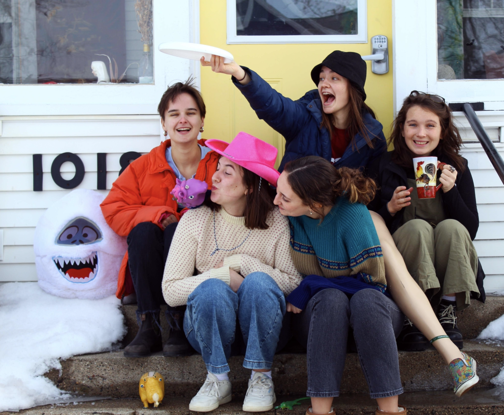 Residents of 1018 East pose on their front porch with some of their favorite knickknacks. Photo by Maddi Shinall. 
