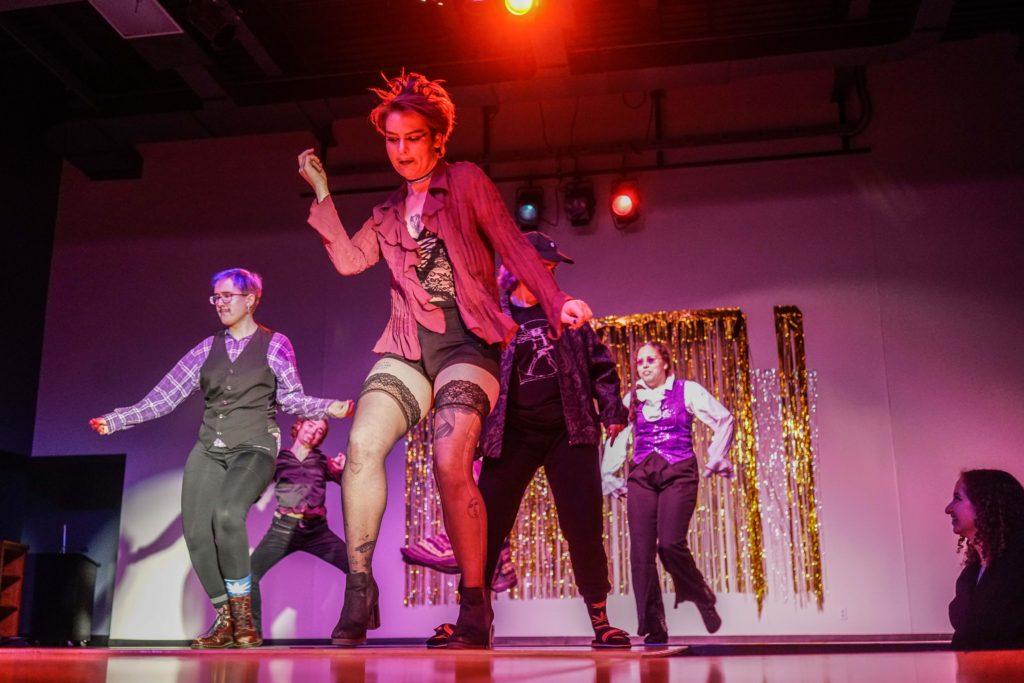 Students dance on stage of Grinnell’s annual drag show during the fall of 2019. Photo by Isabel  Torrence.