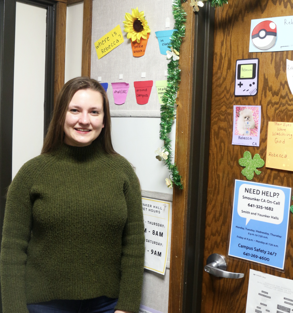 Community Advisor Rebecca Fox `23 in front of her door in Younker Pit. Unless switched to hourly pay, community advisors will be excluded from UGSDW expansion election and resulting bargaining unit. Photo by Ohana Sarvotham.