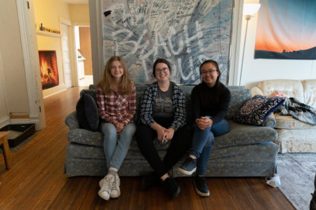 Eva Hill, Maren Cooper and Linda Peng, all `22, pose on one of their couches. Photo by Paul Hansen. 
