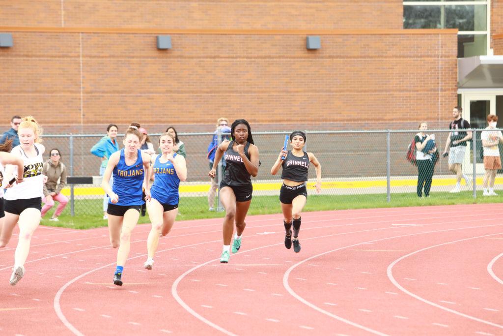 Paige Olowu `22 runs ahead of her teammate Eva Carchidi `24 before taking the baton. Photo contributed by Ted Schultz.