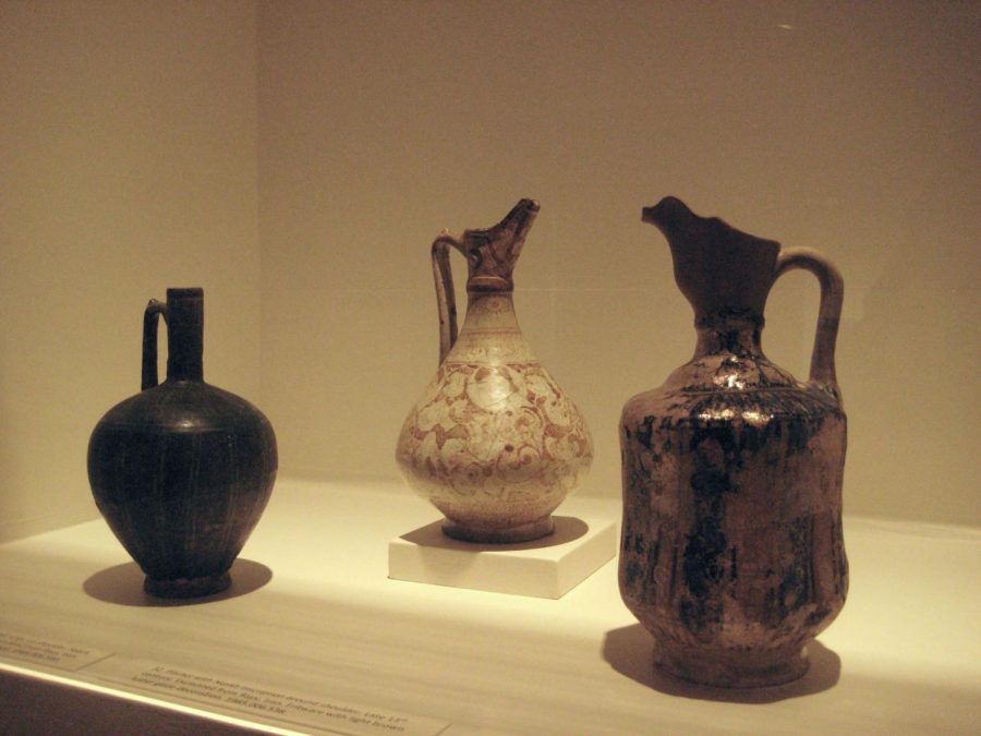 Left to right: Silhouette-Ware Ewer with Nashki script on shoulder. Late 12th - early 13th century, Iran. Fritware with black slip under turquoise glaze. Pitcher with Naskh inscription around shoulder. Late 13th century, Iran. Fritware with light brown luster glaze decoration. Ewer. Late 12th century, Syria. Fritware, underglaze blue and turquoise with luster over transparent glaze.
