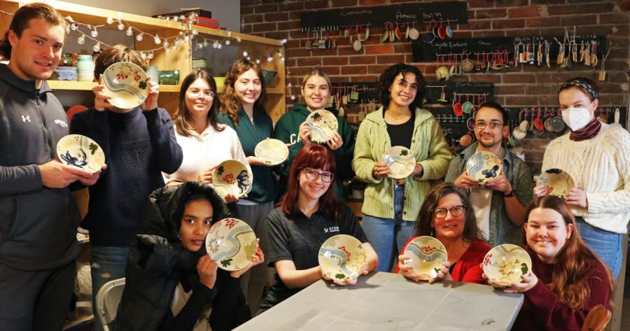 Students in HUM/SST-120 Introduction to Material Culture Studies hold up their donations to Empty Bowls. 