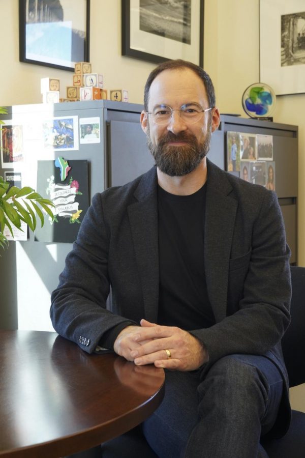 Caleb Elfenbein posing in his office