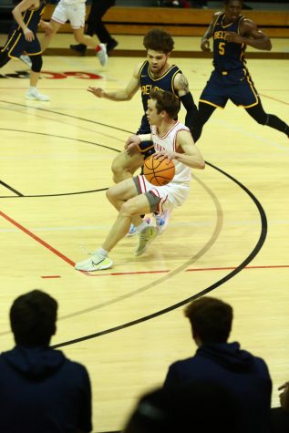 Aiden Gilbert `23, guard, drives the ball down court in the Feb. 14 game
against Beloit College.