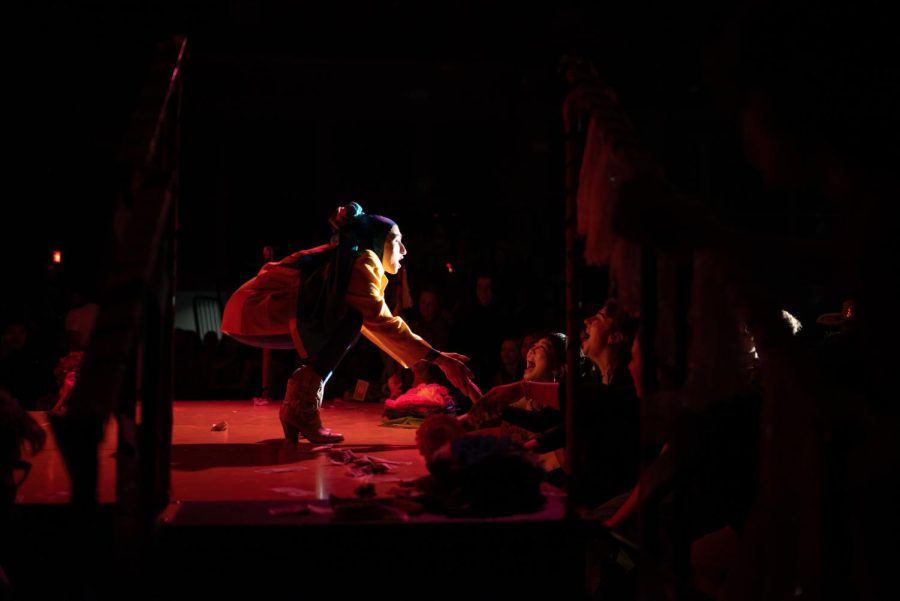 Auntie Fa crouched at the front of the stage reaching out to her adoring fans.