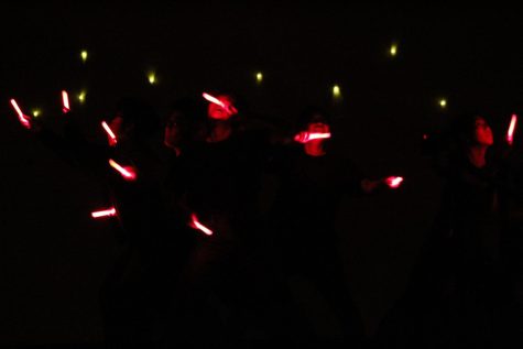 Red glow sticks held by members of Japanese Cultural Association light up their faces as their waved through the air.