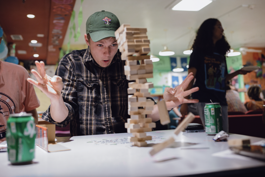 A+student+reacts+in+surprise+as+a+jenga+tower+crumbles+before+them.