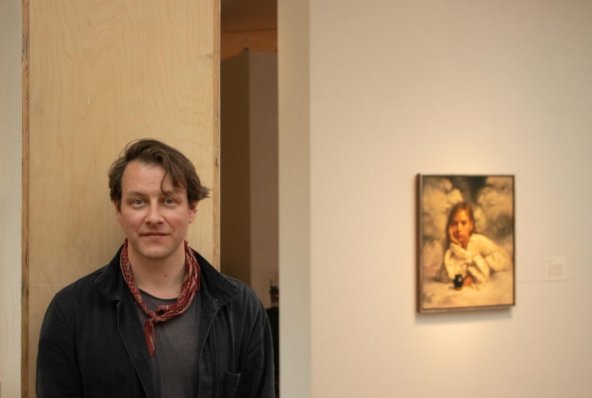 Stephen Appleby-Barr stands next to his work in his exhibition, Correspondence.