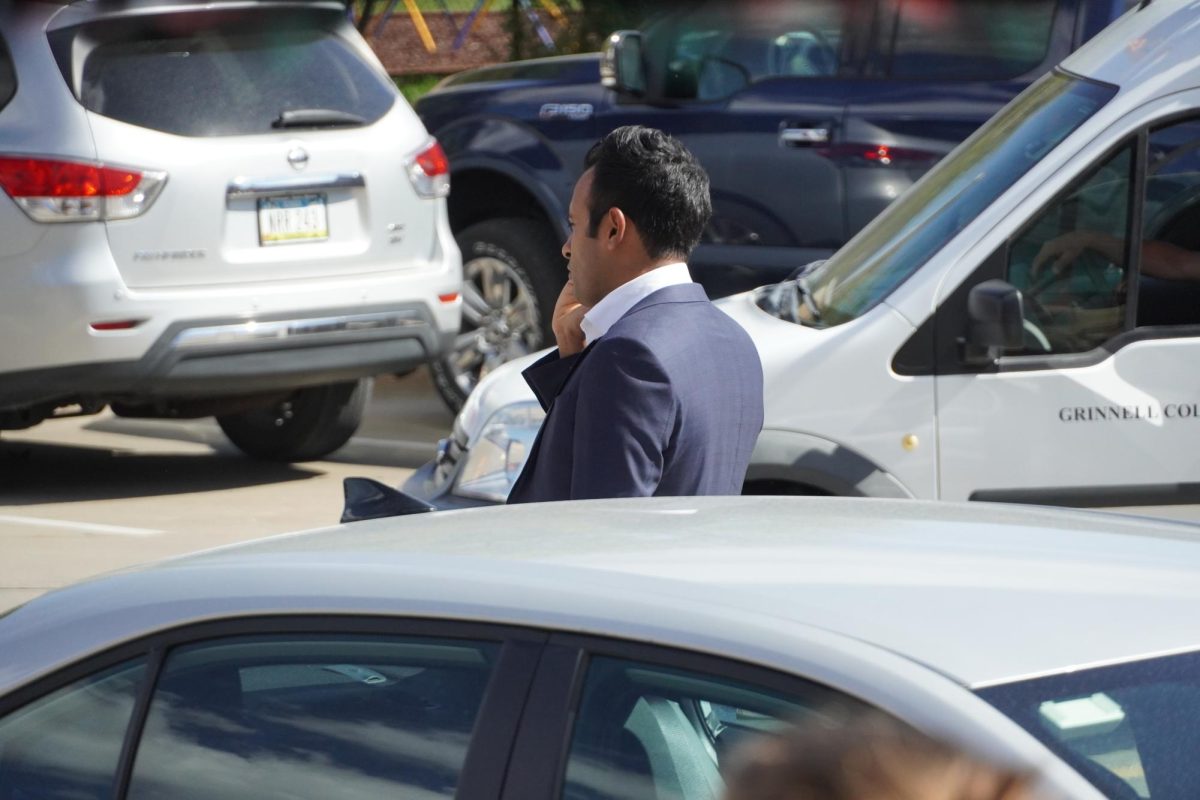 Ramaswamy's talks on the phone as he prepares to walk into the event in Grinnell on Oct. 5, 2023. Moments later, a Grinnell College students accidentally backed into a campaign vehicle.