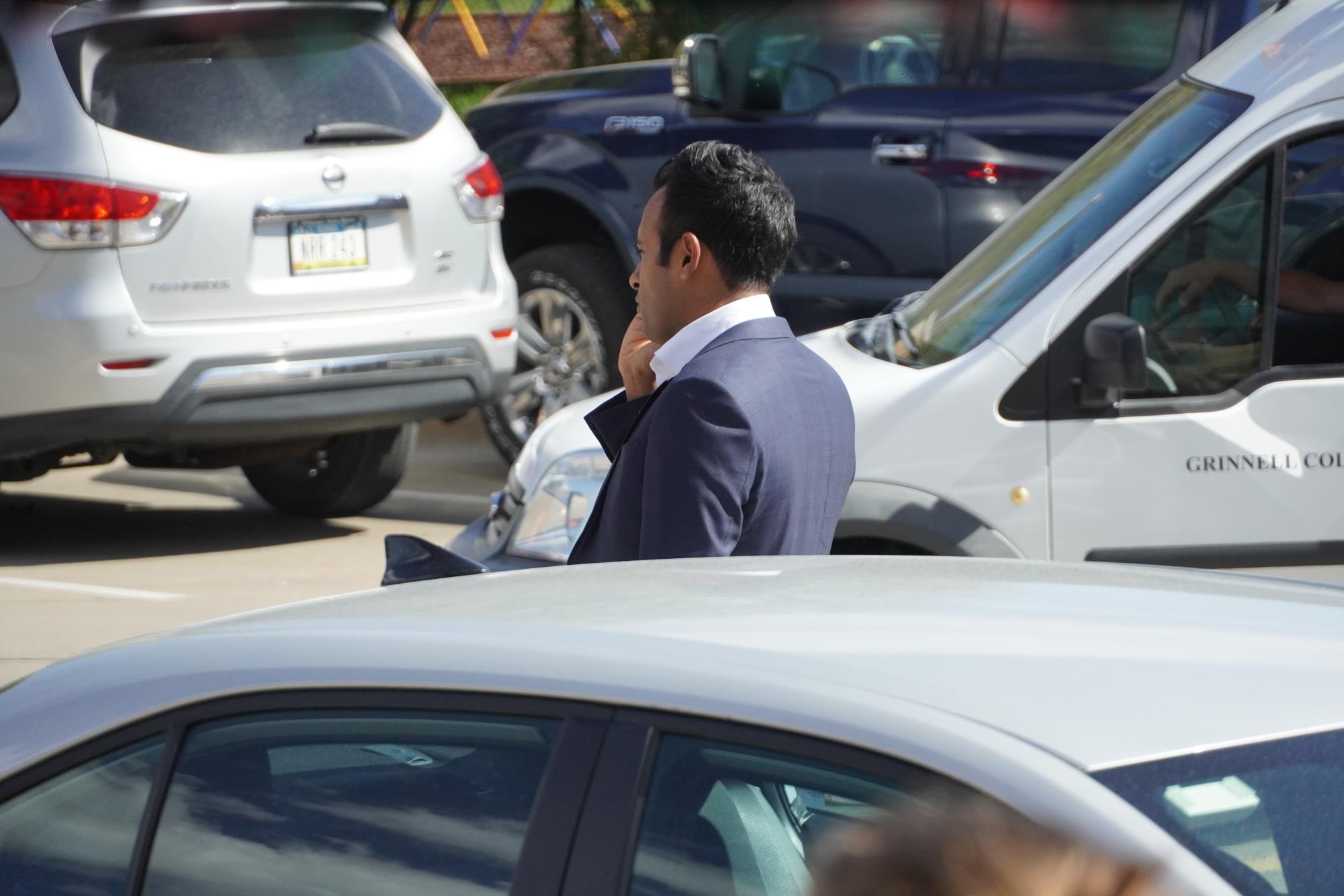 Ramaswamys talks on the phone as he prepares to walk into the event in Grinnell on Oct. 5, 2023. Moments later, a Grinnell College students accidentally backed into a campaign vehicle.