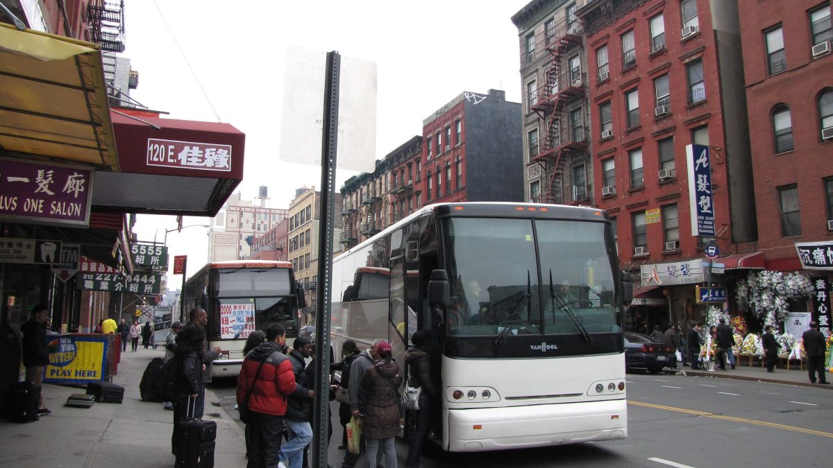 People line up for a bus in New York City, NY, one of several sanctuary cities in the United States.