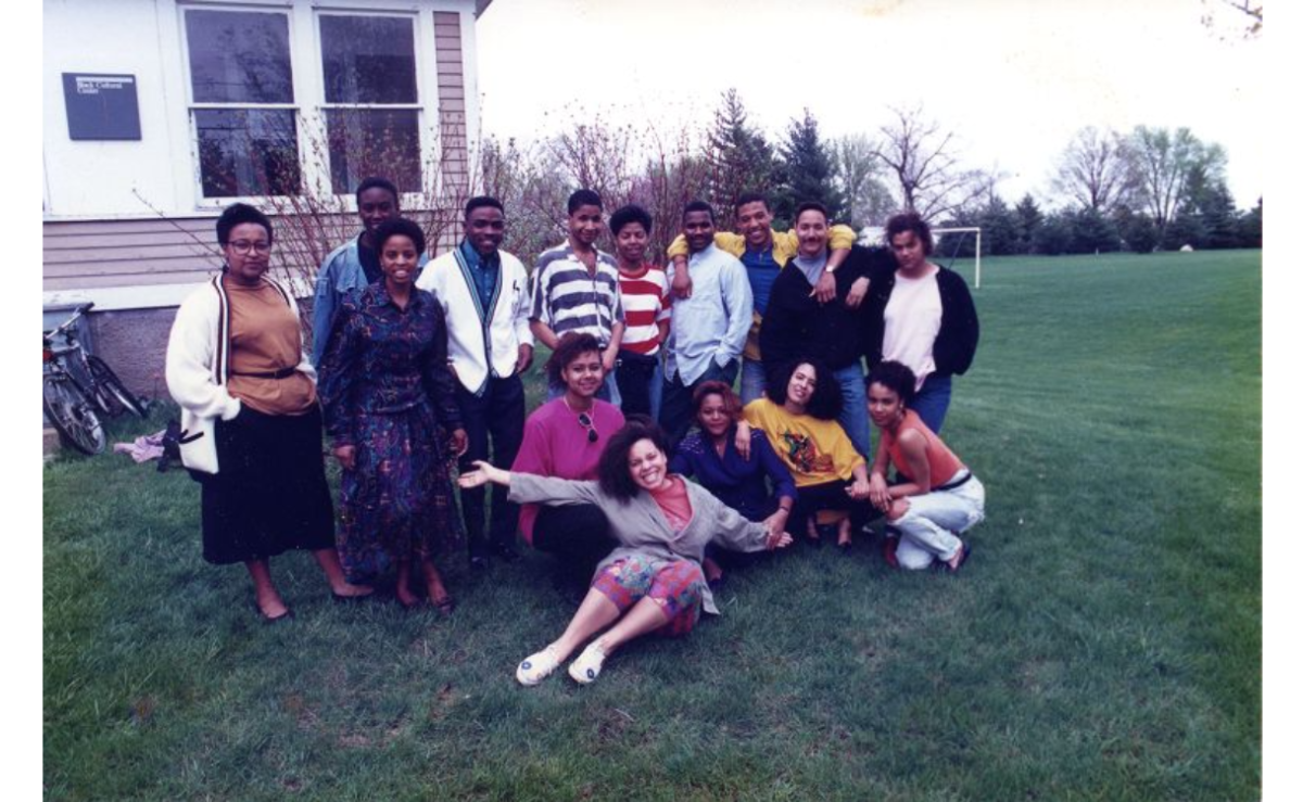 This undated archival photo shows 15 students posing for a photograph outside of the Black Cultural Center (BCC).