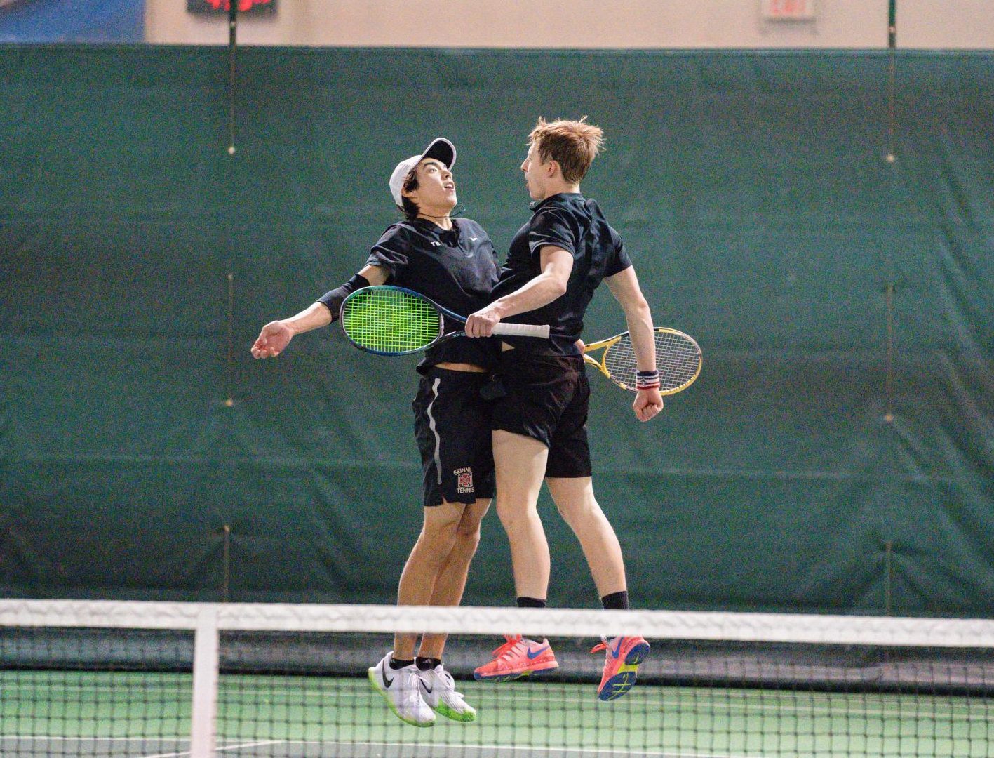 From left: Lucas Willett `26 and Karch Knoll `25 chest bump during their doubles match against Iowa Central Community College. They won their match 8-6, and the Pioneers won the matchup 5-4.