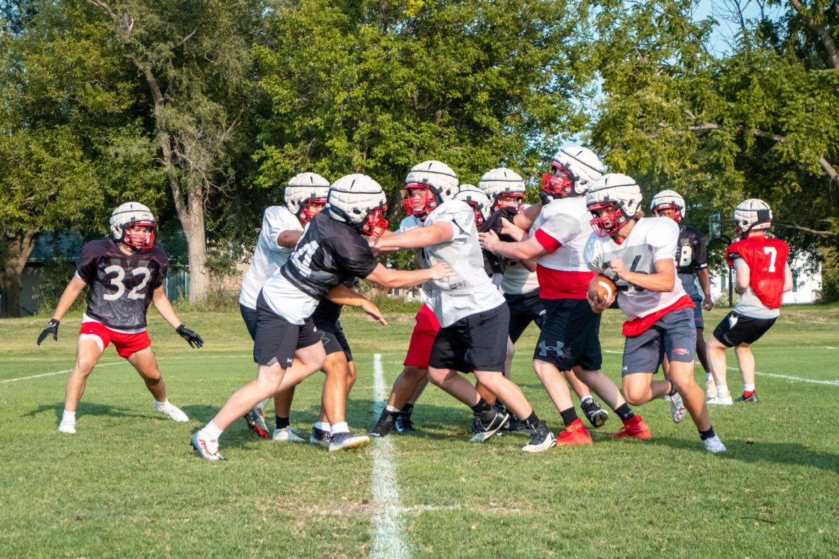 Members of the football team practicing in August 2023.