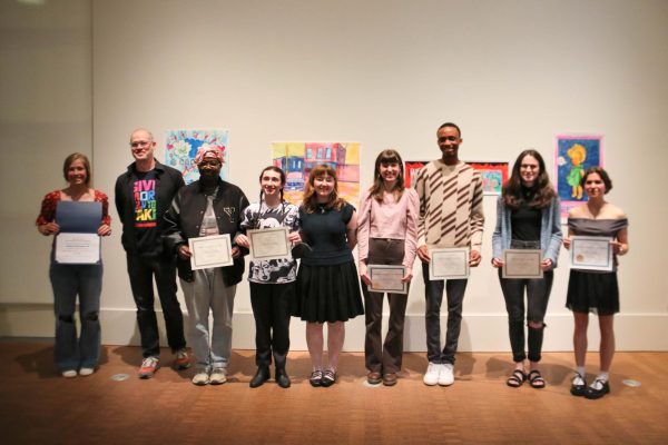 Meilynn Smith   
Juror Luther Davis `09 stands with Bachelor of Arts Exhibition award winners from left: Kathryn Vermeulen `26, Karis McCaskill `24, Kelly Banfield `24, Georgia Carbone `24, Stella Lowery `24, Nora Leahy `24 and Alina Ihnatesku `26.