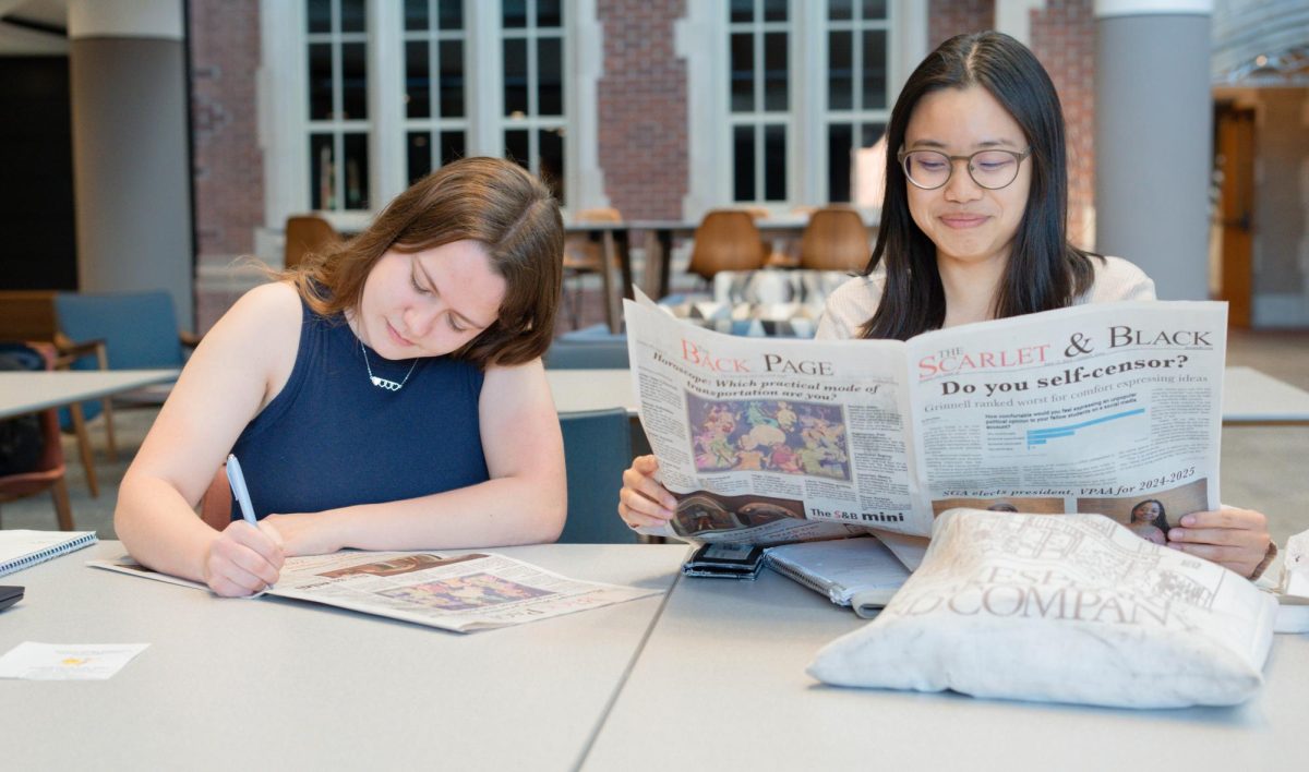 From left: Alyvia Bunkowski `26 and Cadence Chen `26 with The S&B in the Humanities and Social Studies Center.