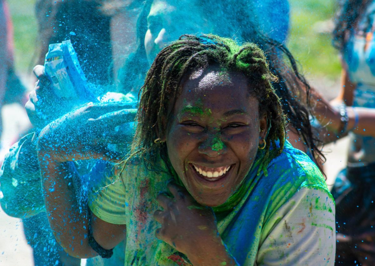 Jemzy Alabi `24 flees from a bombardment of non-stain colored powder.
