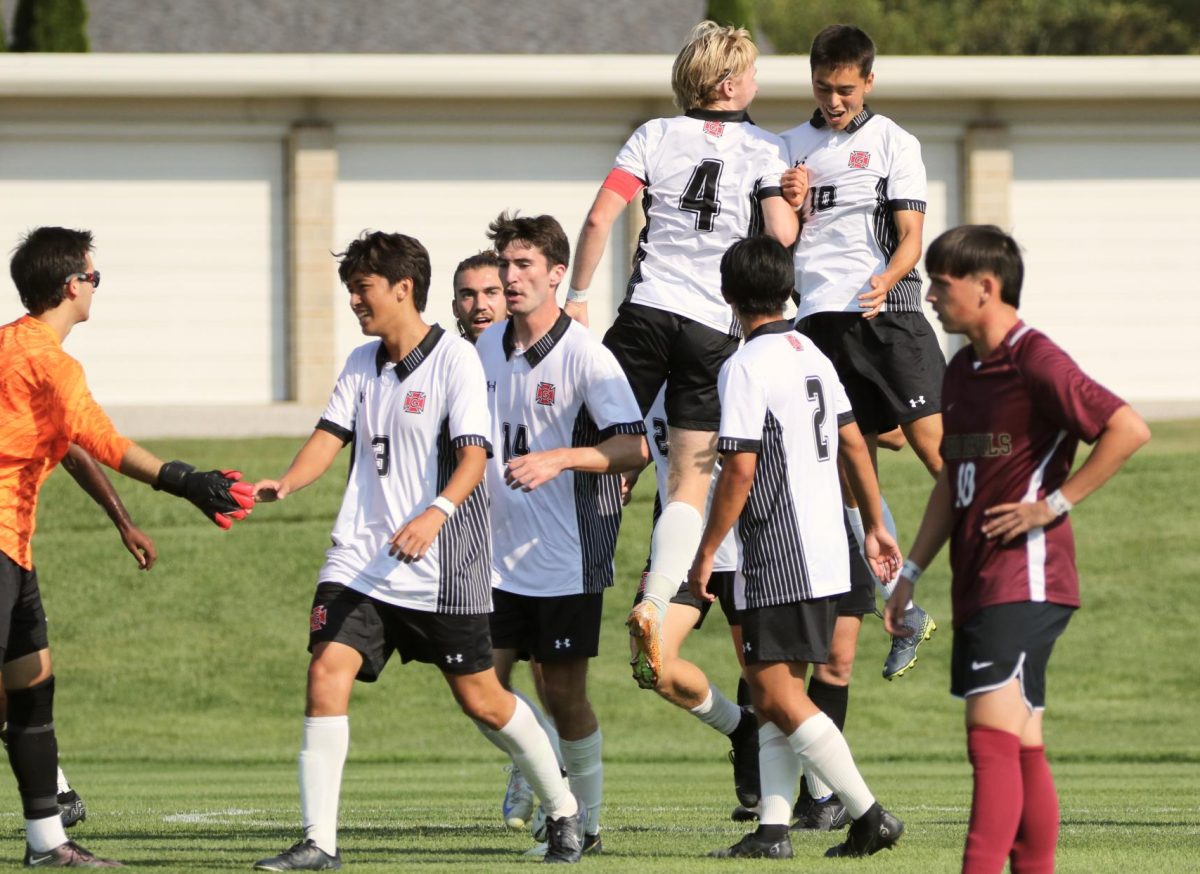 Dylan Maddux (10) celebrates with Evan Larson (4) after scoring during a game against Eureka College at Springer Field on Sunday, Sept. 8, 2024.