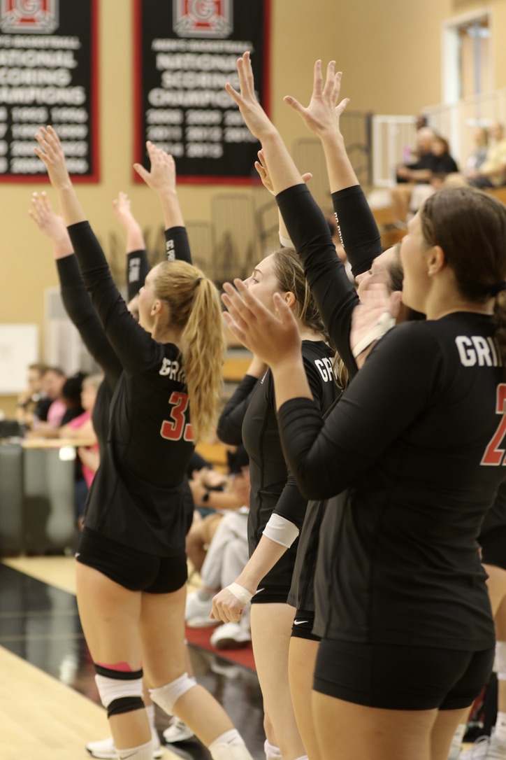 The Grinnell volleyball team celebrates after winning the first set during a game against Nebraska Wesleyan University at Darby Gym on Wednesday, Sept. 11, 2024