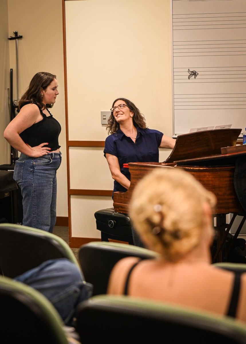 Andra Velis Simon, workshop director, praises and gives feedback to student, Libby '27 (left) after singing her audition piece.