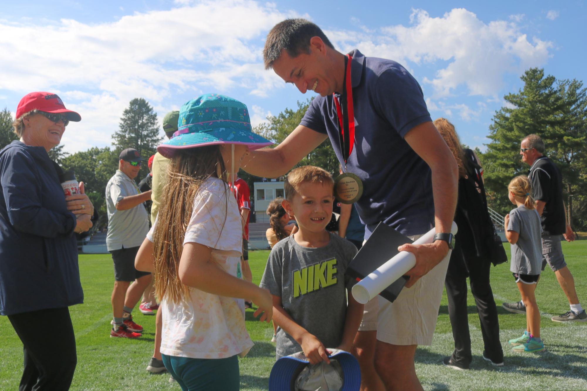 Felipe Bautista `02 celebrates with his family after receiving his medal.