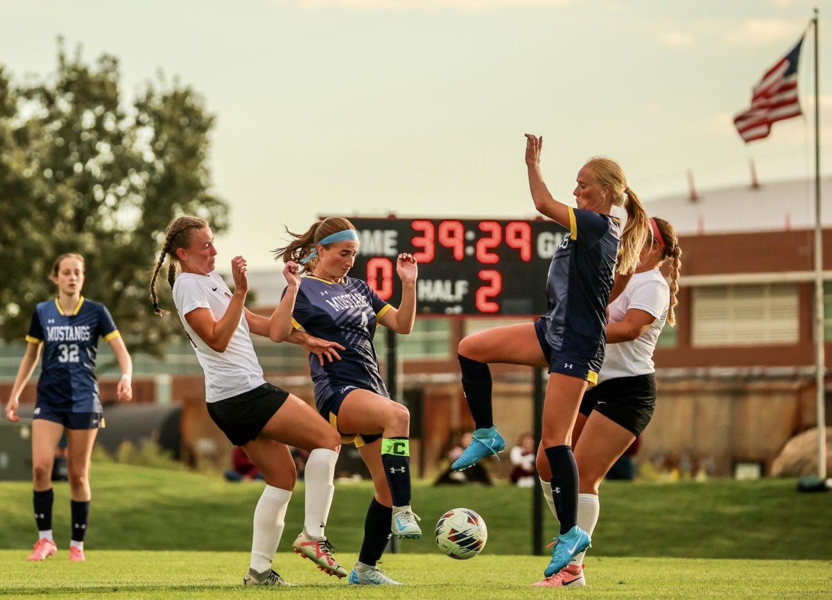 Giada Bambi (24), left, and Reese Komsthoeft (21) attempt to win a loose ball against two opponents during a game against Mount Mercy University at Springer Field on Friday, Sept. 6, 2024.