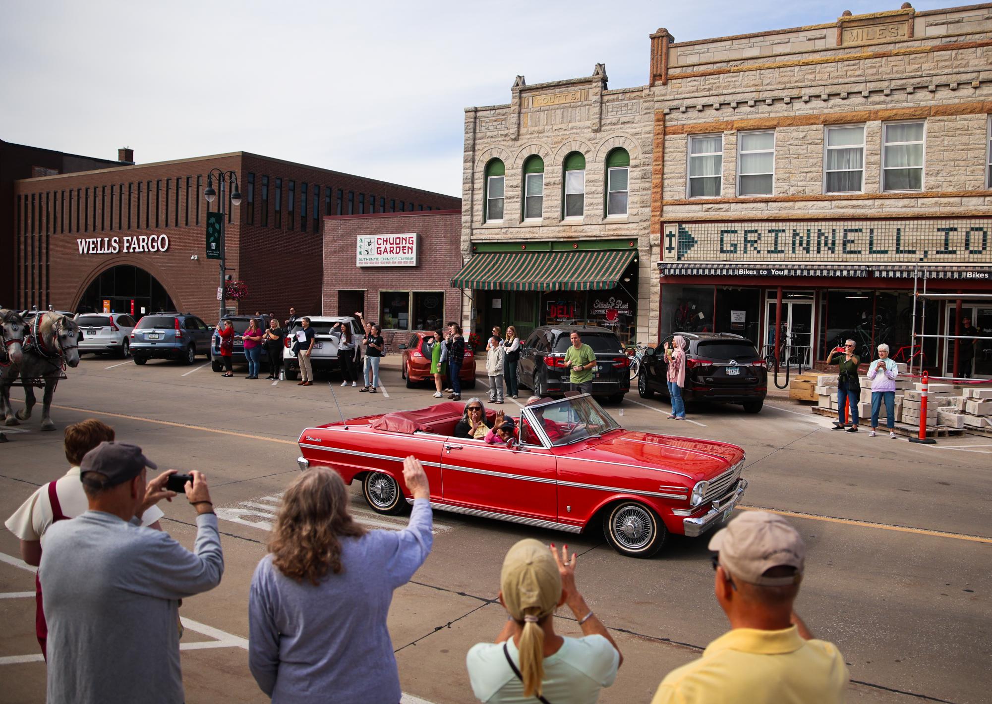 Members of the Grinnell community line Broad Street as Edith Renfrow Smith passes by during the Welcome to Grinnell Parade on Friday, Sept. 27, 2024.