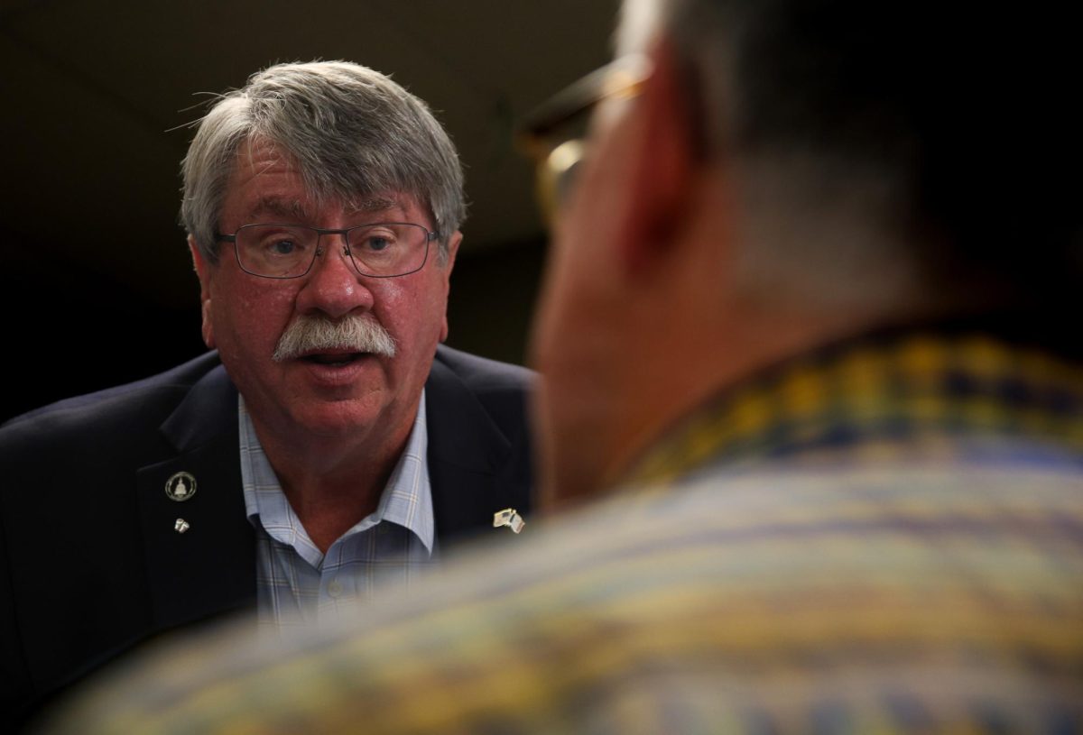 Dean Fisher speaks with a constituent after a candidates forum hosted at Tama American Legion on Sept. 30. 