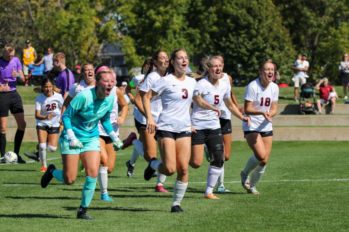 The starting line up runs back to the bench to do the pregame cheer.